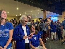 Sister Percylee Hart RSM, principal of Union Catholic Regional High School in New Jersey, sits in front a crowd of students, staff, and alumni as the crowd cheers on Sydney McLaughlin in her Gold medal race at the Tokyo Olympics.